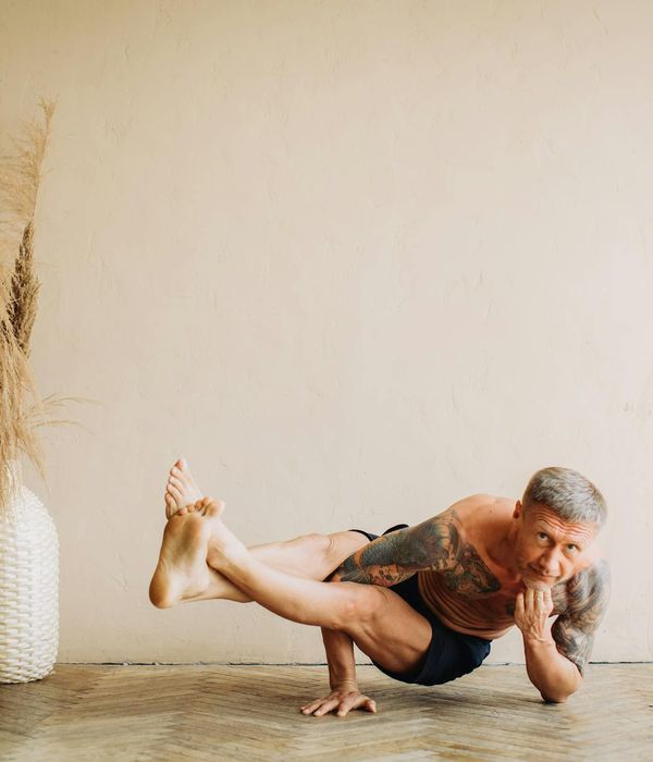 Man performing a controlled strength exercise in a calm environment.